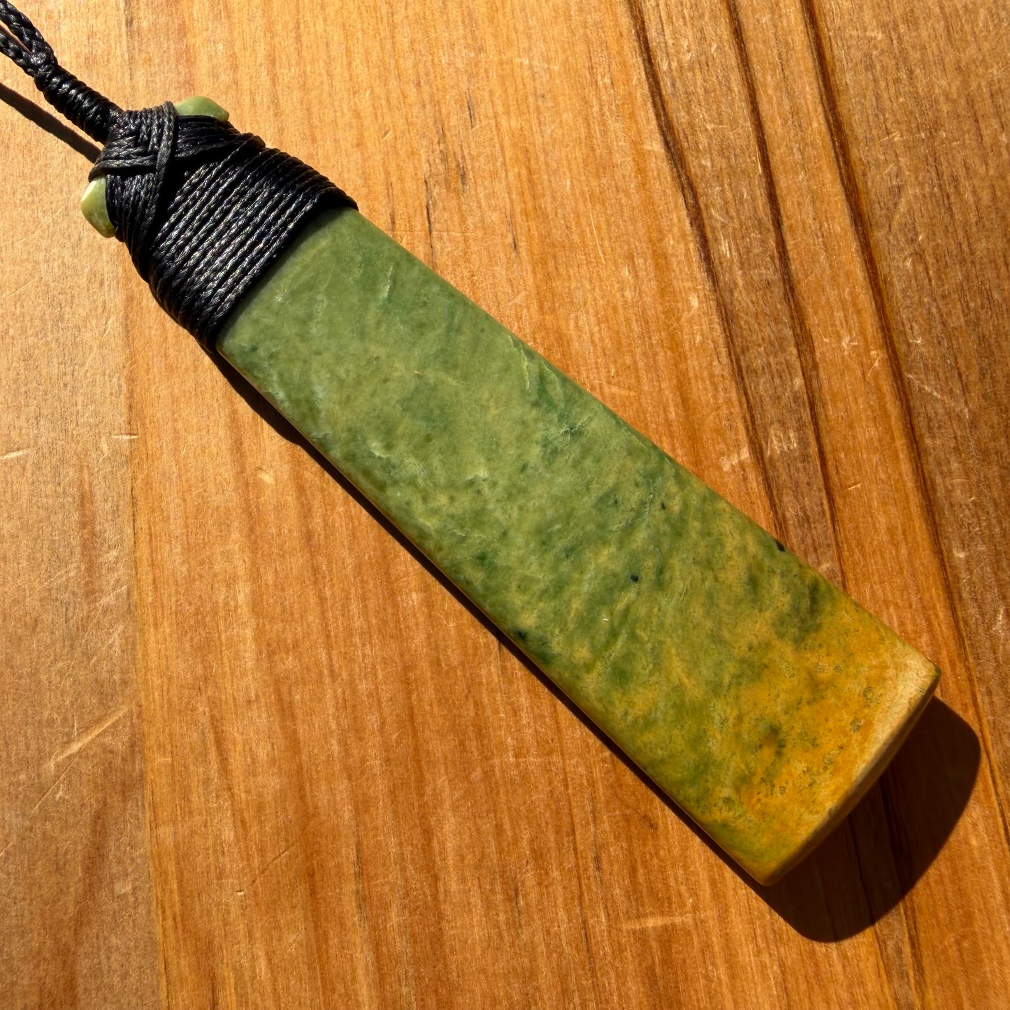 Bound pounamu toki pendant hand-carved from New Zealand Marsden Flower Jade pounamu (greenstone). Back.
