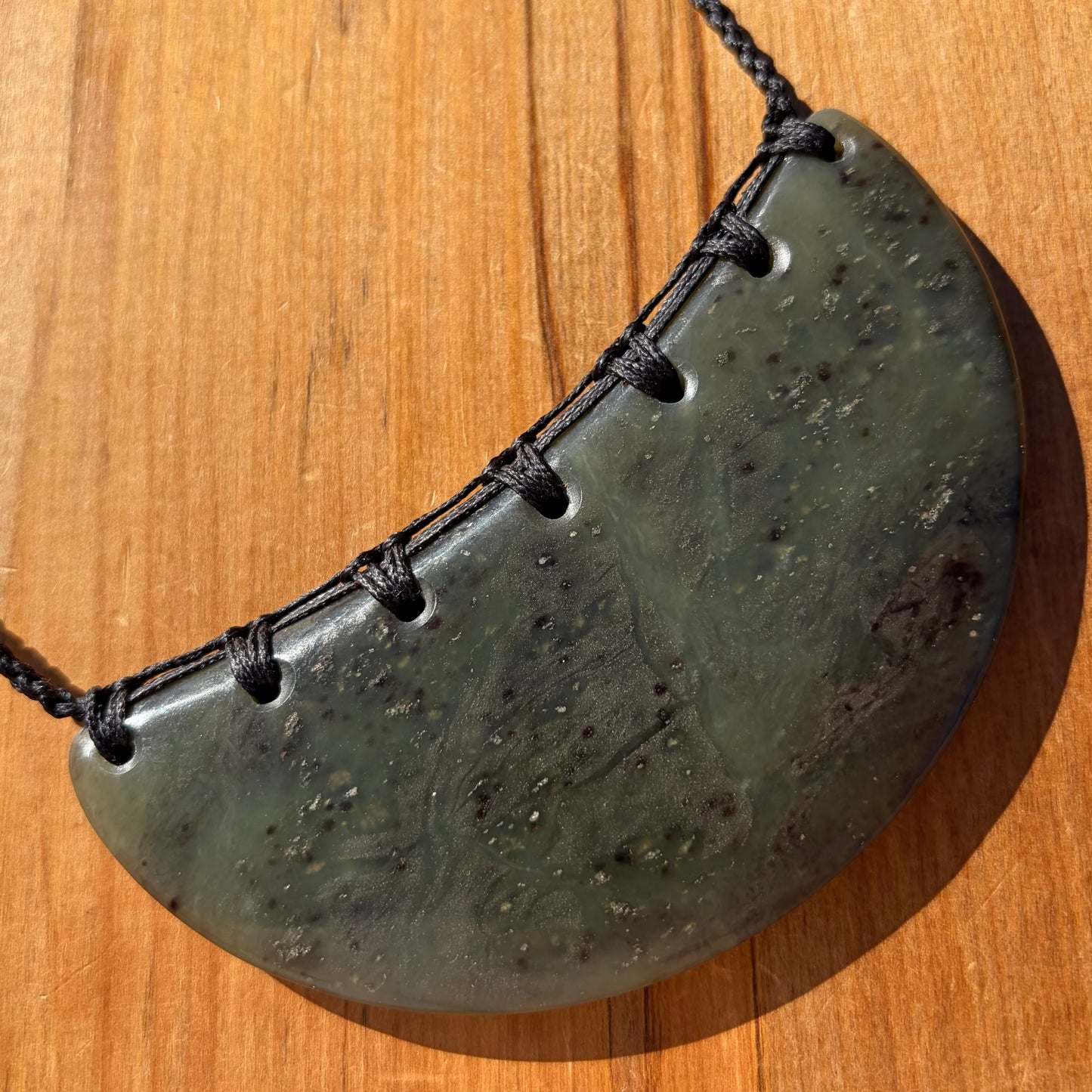 Breastplate pendant hand-carved from New Zealand kawakawa pounamu (greenstone). Front.