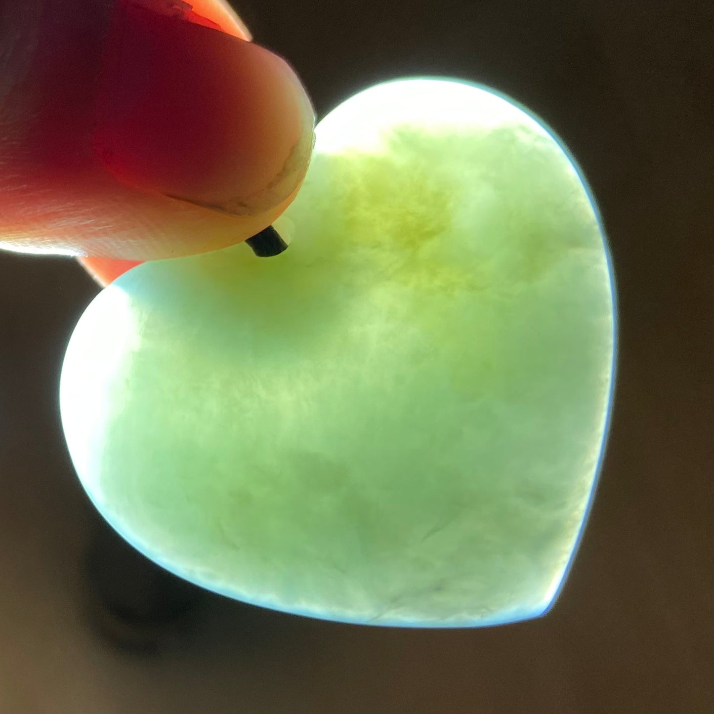 Heart shaped pendant hand-carved from New Zealand inanga pounamu (greenstone). Translucency.