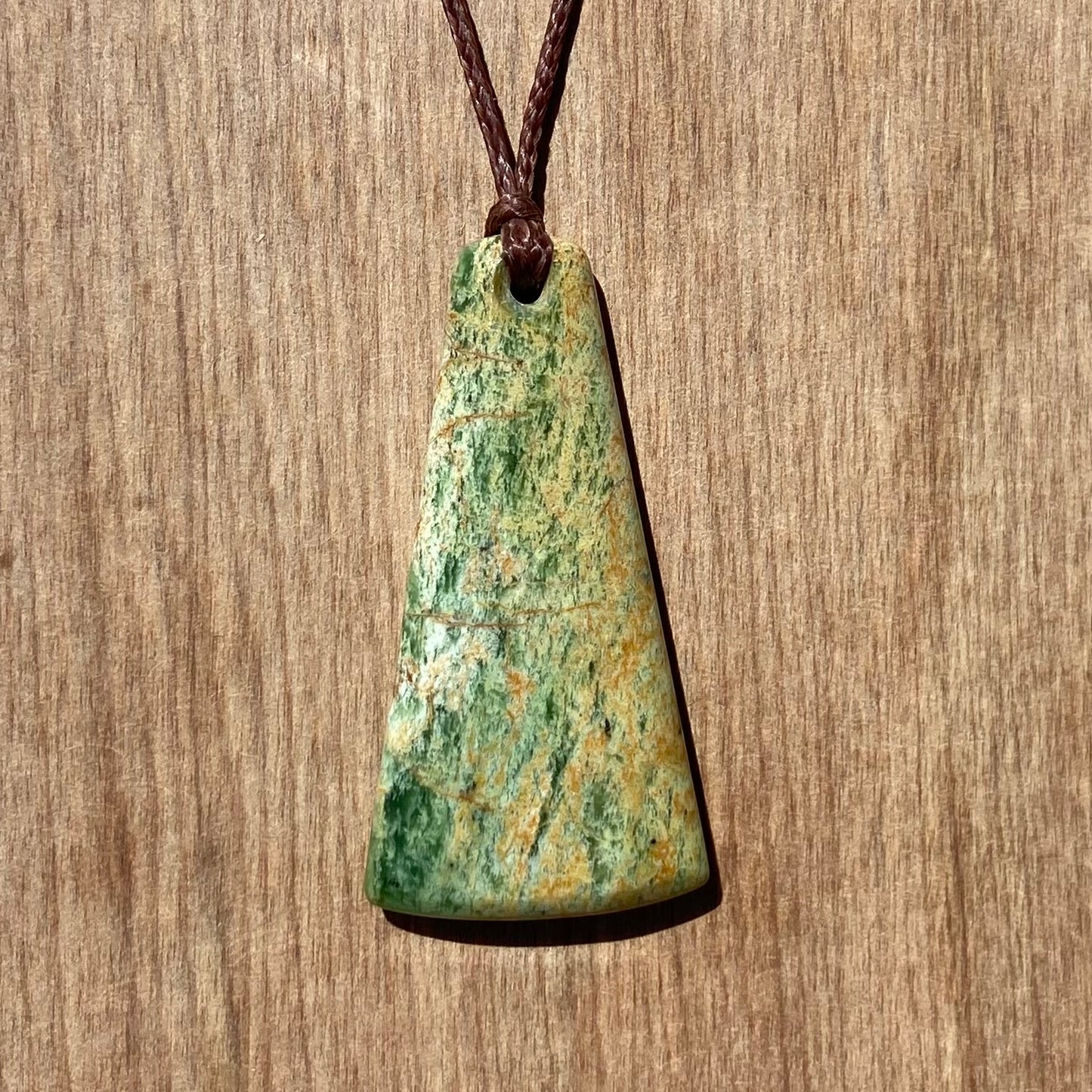 Toki pendant hand-carved from New Zealand Marsden Flower Jade/ pounamu (greenstone). Back.