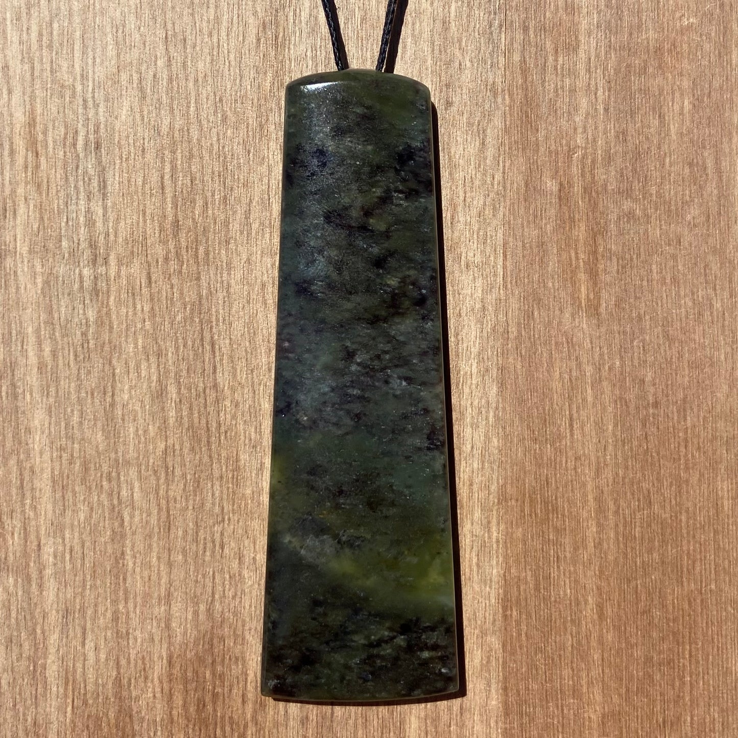 Toki pendant hand-carved from New Zealand totoweka pounamu (greenstone). Back.