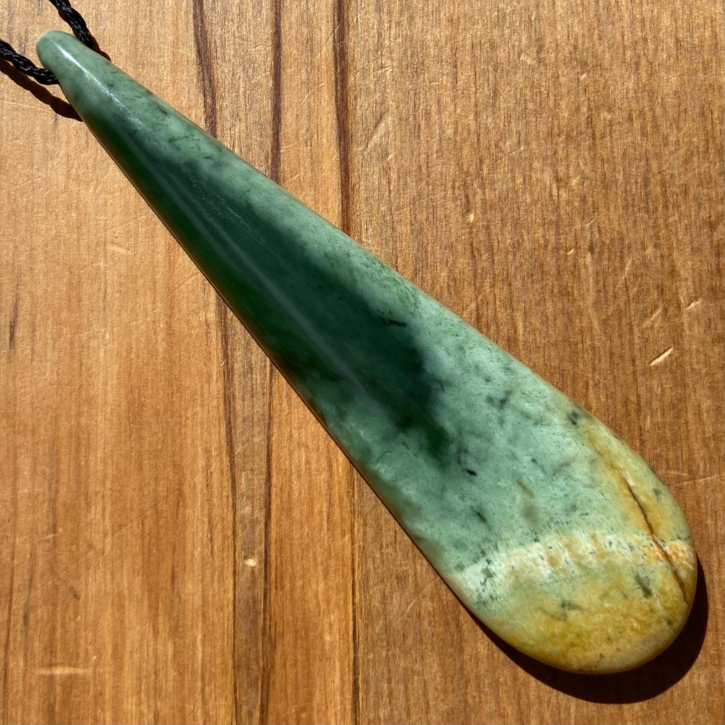 XL roimata teardrop pendant carved from New Zealand Marsden Flower Jade (greenstone). Back.