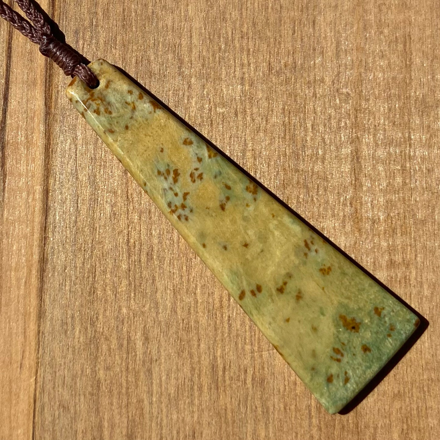 Toki pendant hand-carved from New Zealand kokopu pounamu (greenstone). Back.