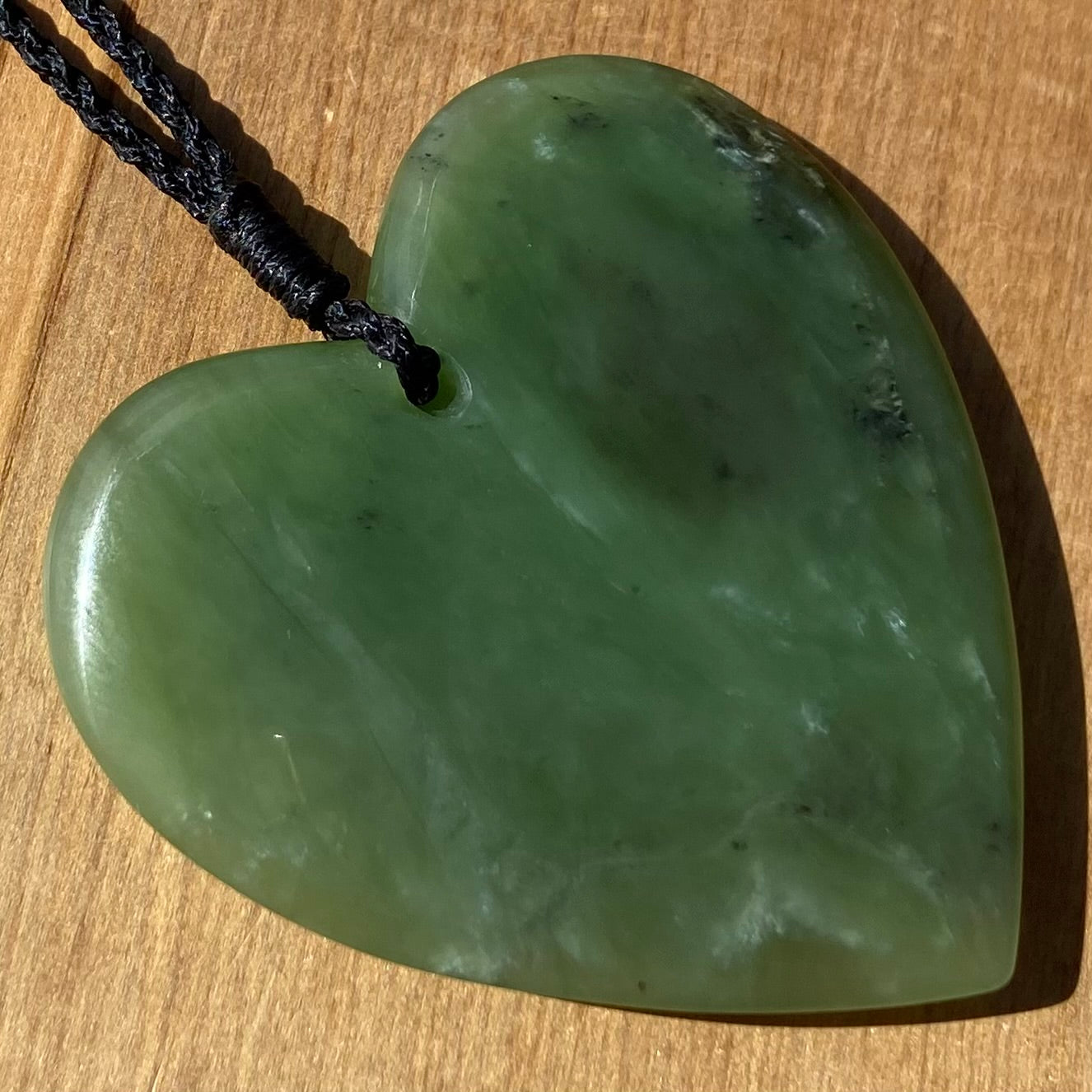 Heart pendant hand-carved from New Zealand kawawkawa pounamu (greenstone). Back.
