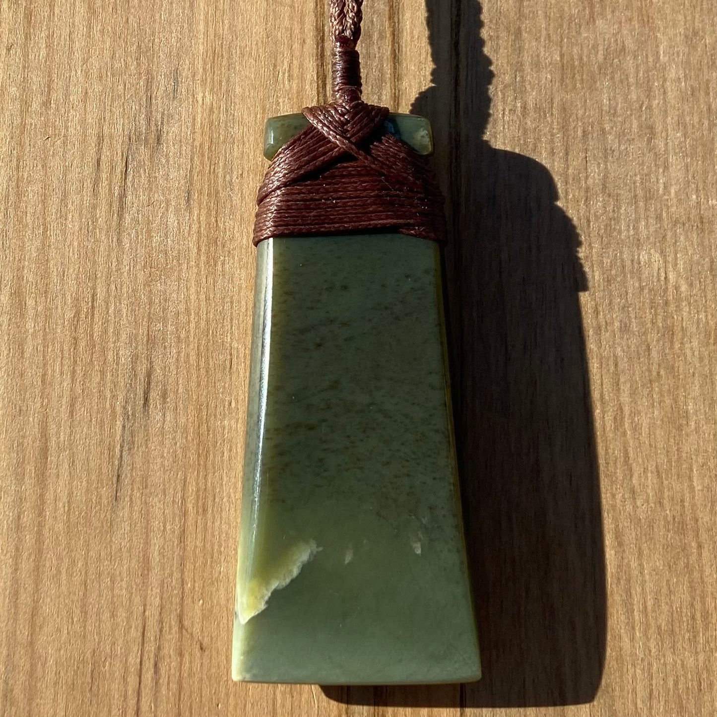 Toki pendant hand-carved from New Zealand kokopu pounamu (greenstone). Back.