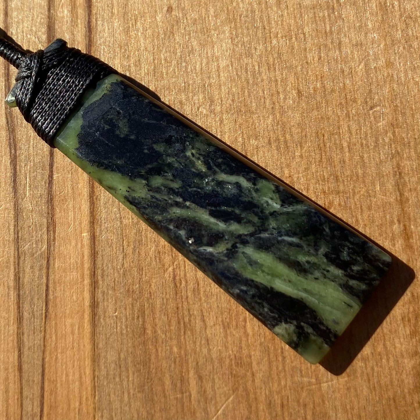Bound toki pendant hand-carved from New Zealand Douglas Creek pounamu (greenstone). Back.