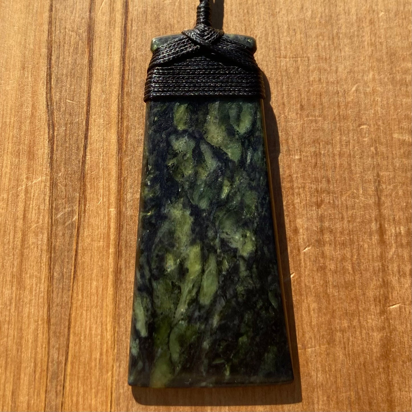 Bound toki pendant hand-carved from New Zealand Douglas Creek pounamu (greenstone). Front.