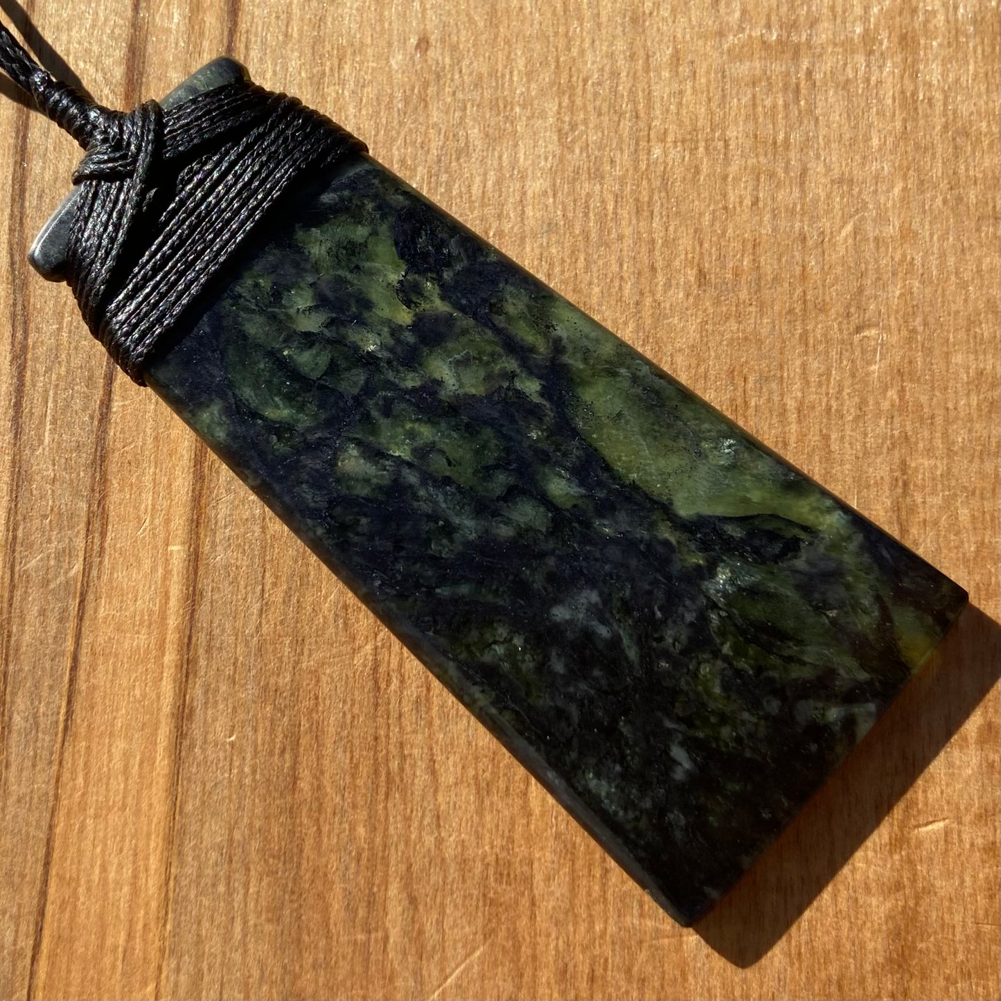 Bound toki pendant hand-carved from New Zealand Douglas Creek pounamu (greenstone). Back.
