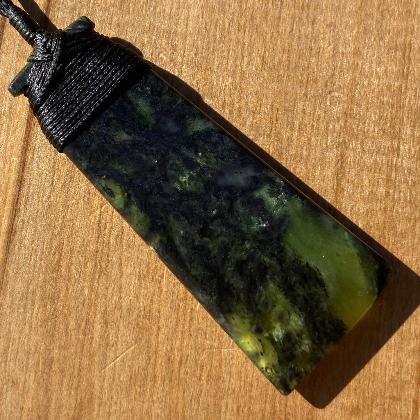 Bound toki pendant hand-carved from New Zealand Douglas Creek pounamu (greenstone). Back.