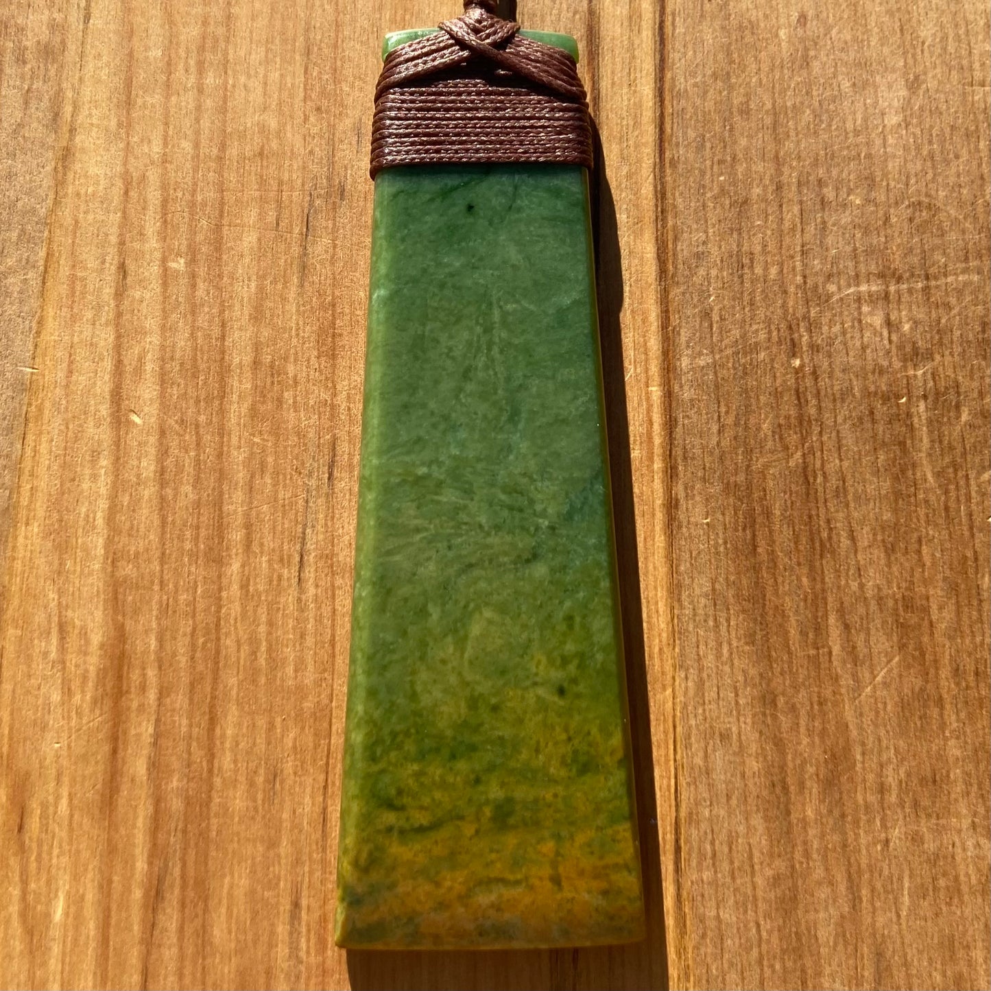 Toki pendant hand-carved from New Zealand Marsden Flower Jade/ pounamu (greenstone). Front.