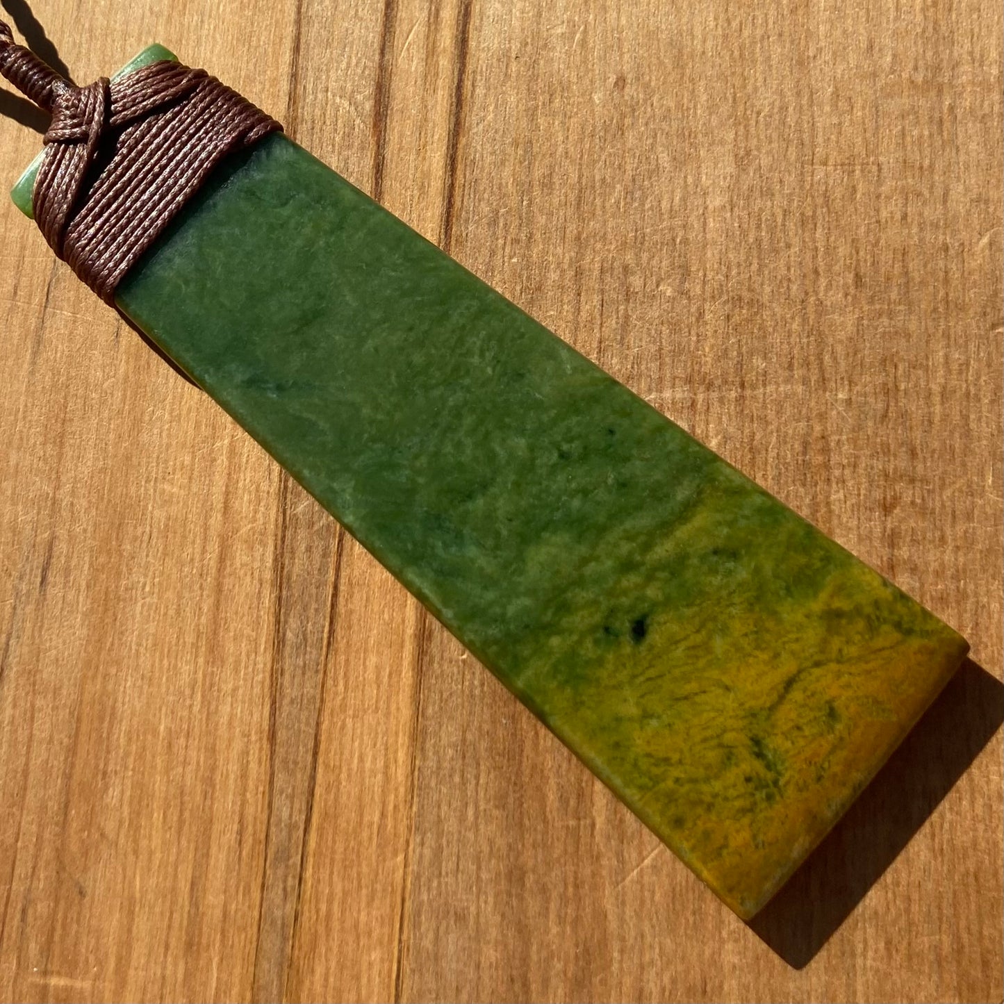 Toki pendant hand-carved from New Zealand Marsden Flower Jade/ pounamu (greenstone). Back.