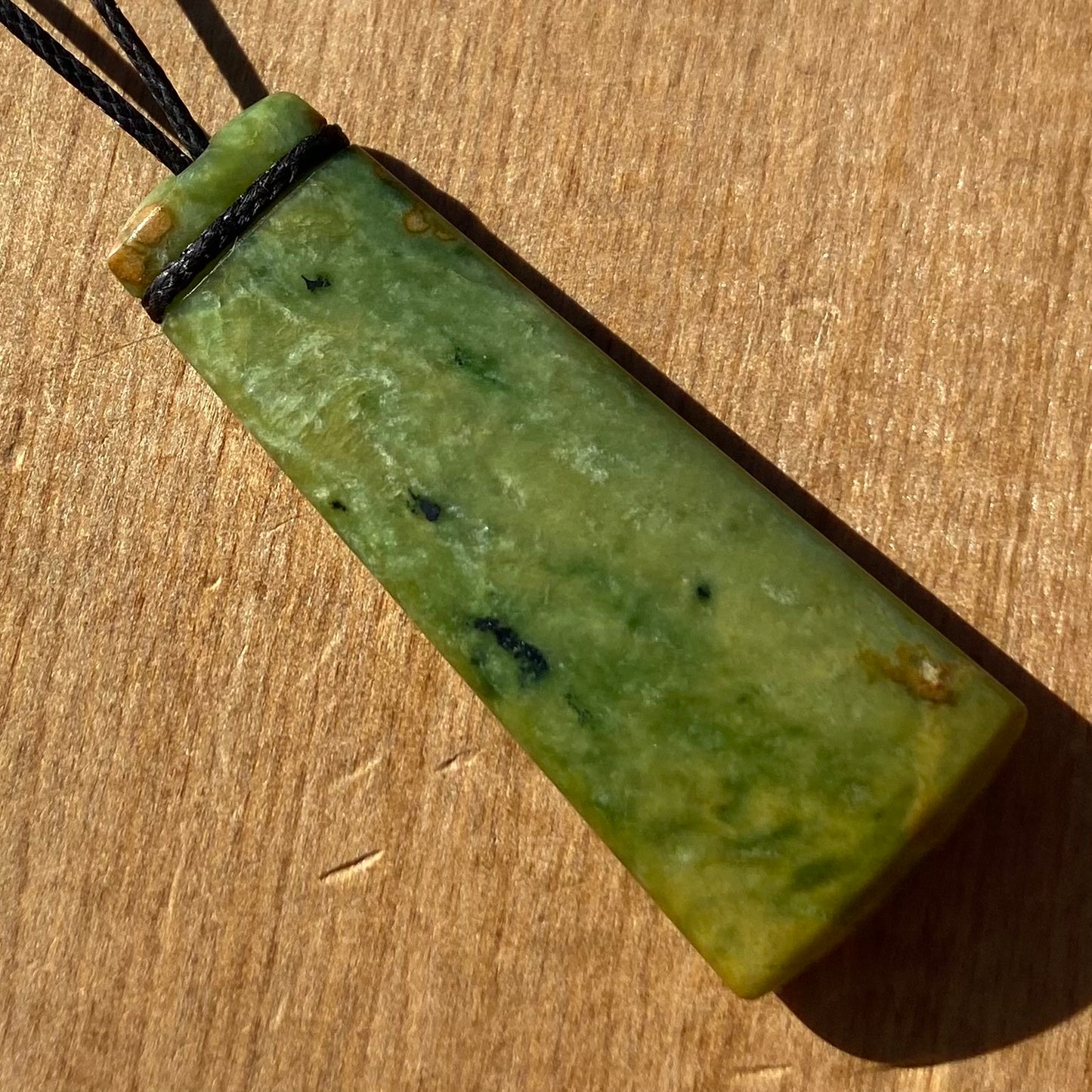Pounamu toki pendant hand-carved from New Zealand Marsden Flower Jade pounamu (greenstone). Front.