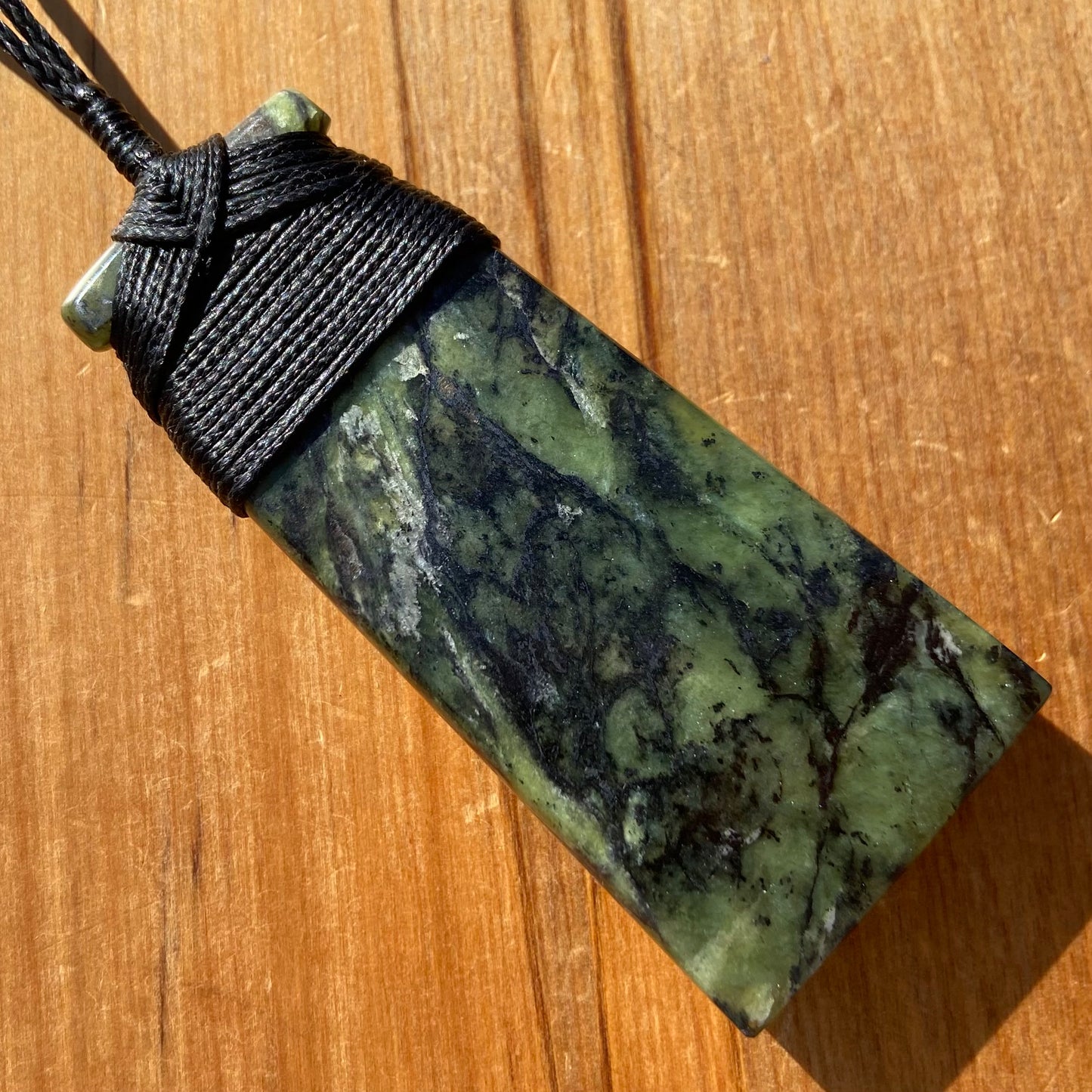 Bound toki pendant hand-carved from New Zealand Douglas Creek pounamu (greenstone). Back.