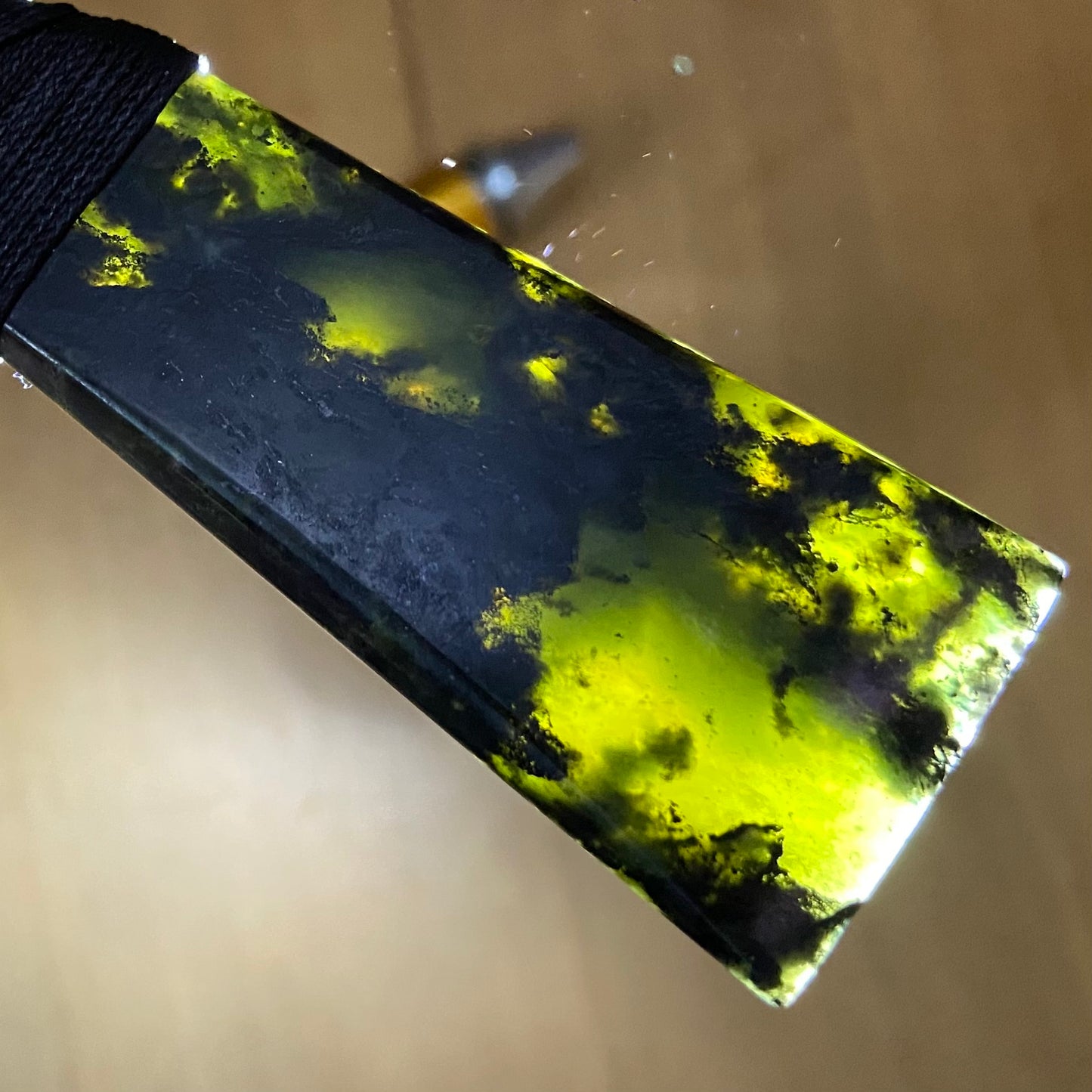 Bound toki pendant hand-carved from New Zealand Douglas Creek pounamu (greenstone). Translucency.