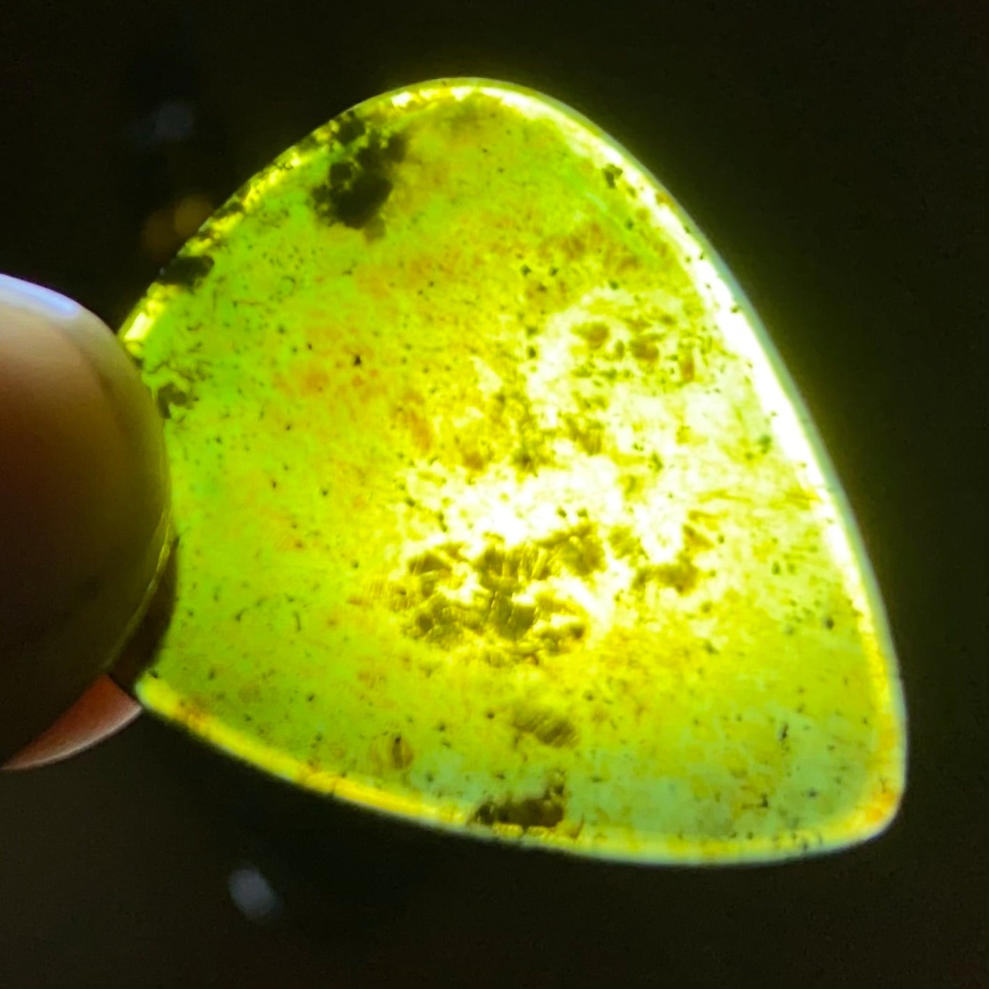 Guitar pick hand-carved from New Zealand tangiwai pounamu (greenstone). Translucency.
