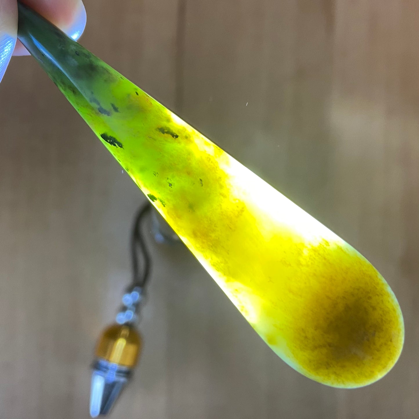 Roimata teardrop pendant hand-carved from New Zealand kawawkawa pounamu (greenstone). Translucency.