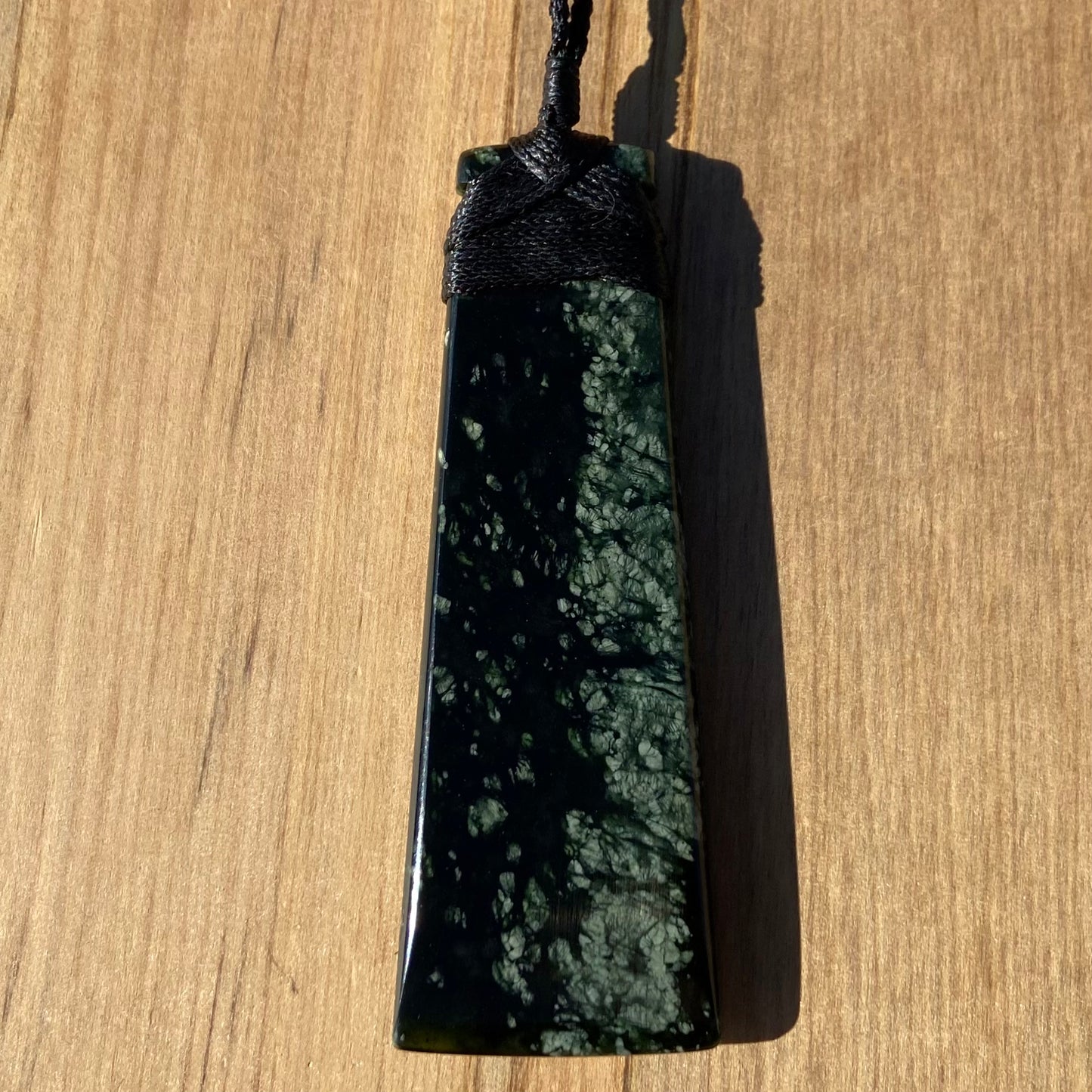 Bound toki pendant hand-carved from New Zealand tangiwai pounamu (greenstone). Back.