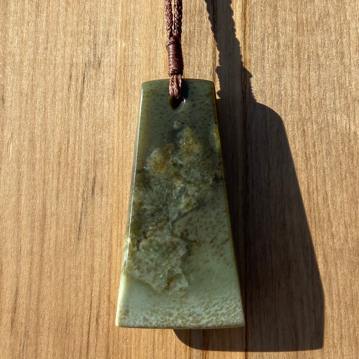 Toki pendant hand-carved from New Zealand kokopu pounamu (greenstone). Back.