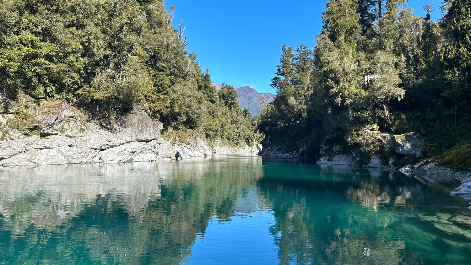 Hokitika Gorge. Bright blue river flowing through bush clad rocks.