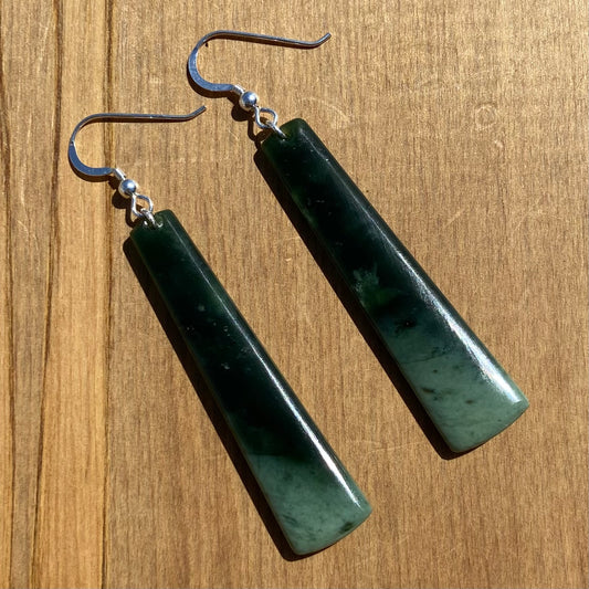 Pair of toki earrings hand-carved from New Zealand Kawakawa Jade/ pounamu (greenstone), with silver fittings. Front.