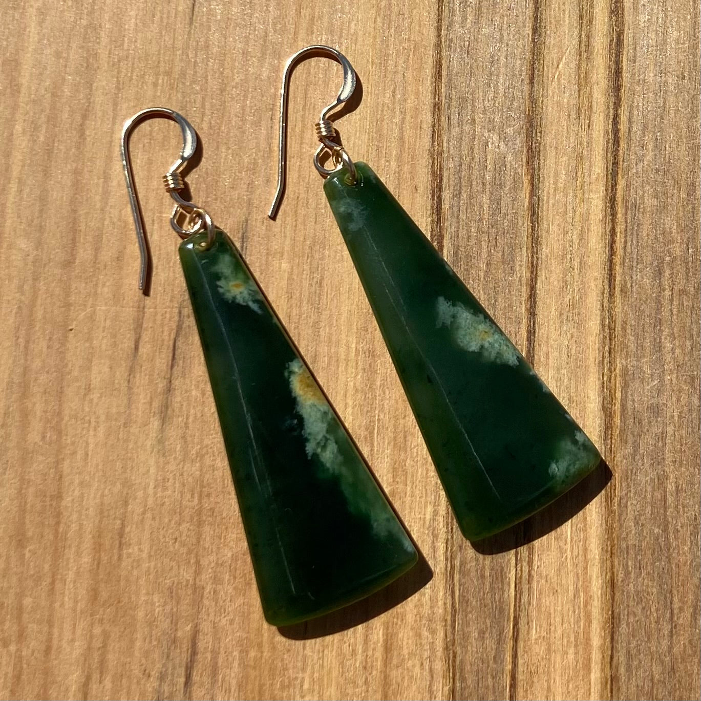 Pair of  toki earrings hand-carved from New Zealand Marsden Flower Jade/ pounamu (greenstone), with gold  fittings. Front.