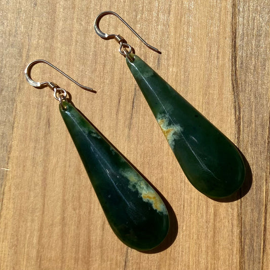 Pair of roimata (teardrop) earrings hand-carved from New Zealand Marsden Flower Jade/ pounamu (greenstone), with gold fittings. Front.