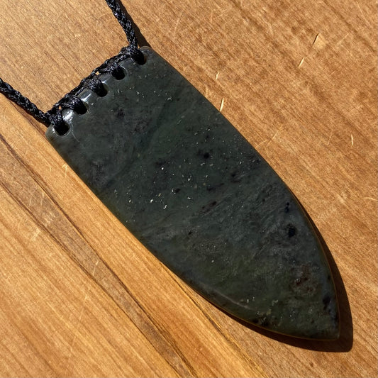 Bound Niho Tooth pendant hand-carved from New Zealand Kawakawa pounamu (greenstone). Front.