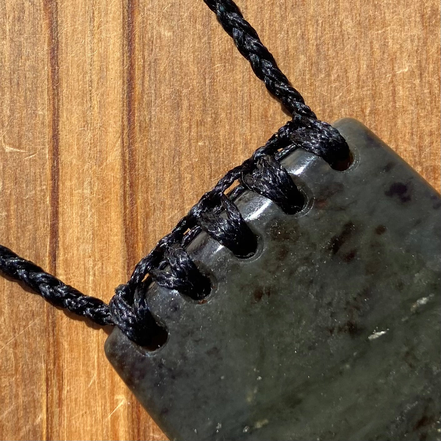 Bound Niho Tooth pendant hand-carved from New Zealand Kawakawa pounamu (greenstone). Binding.