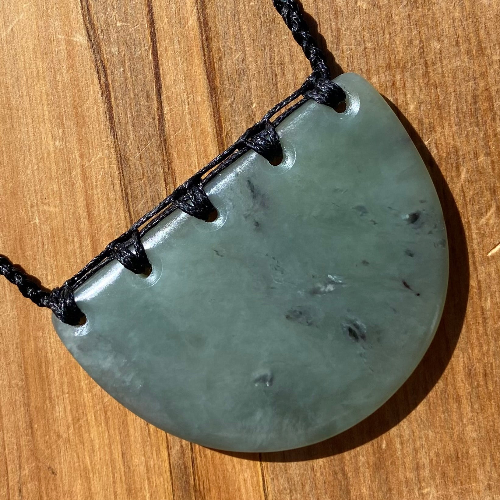 Breastplate pendant hand-carved from New Zealand inanga pounamu (greenstone). Front.
