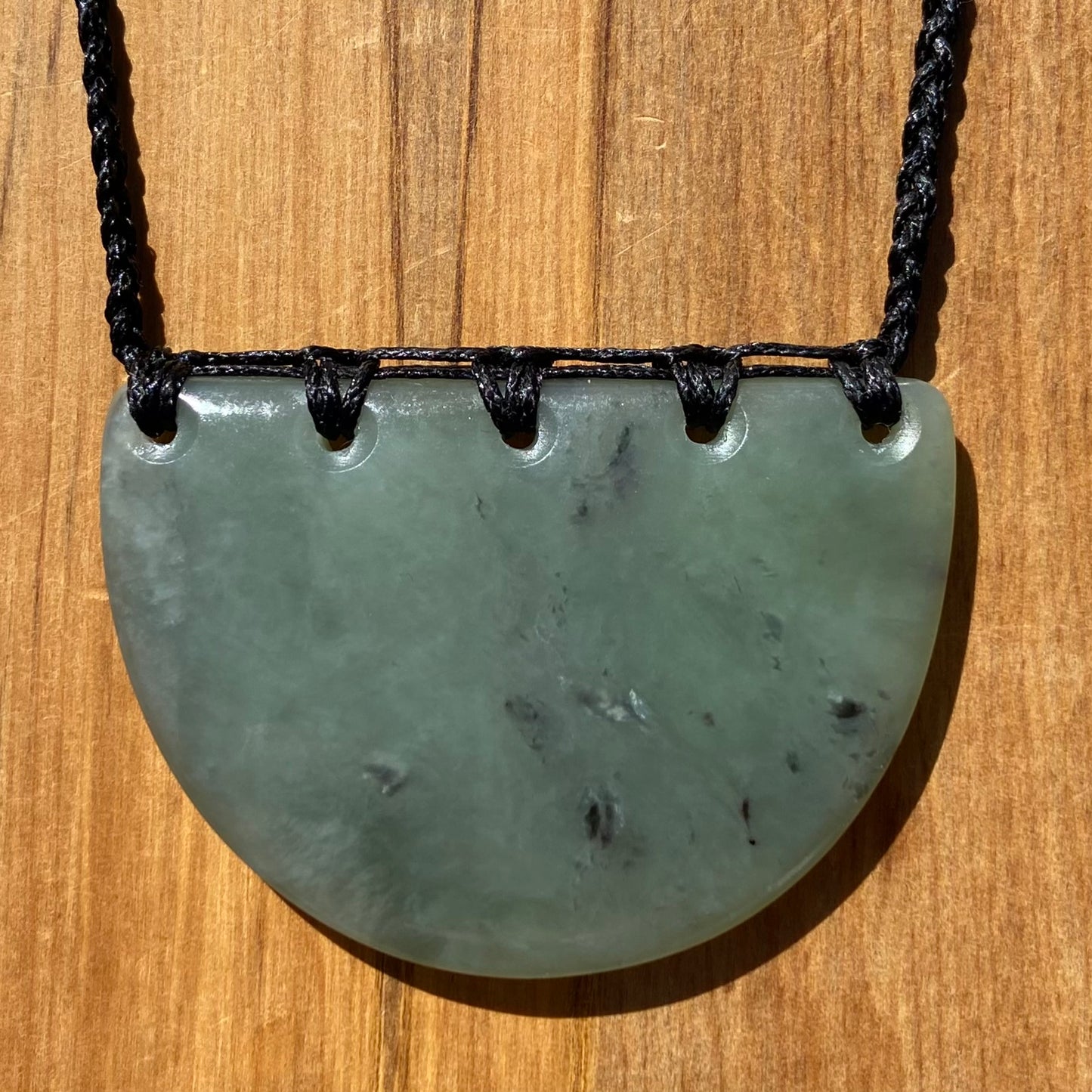 Breastplate pendant hand-carved from New Zealand inanga pounamu (greenstone). Front.