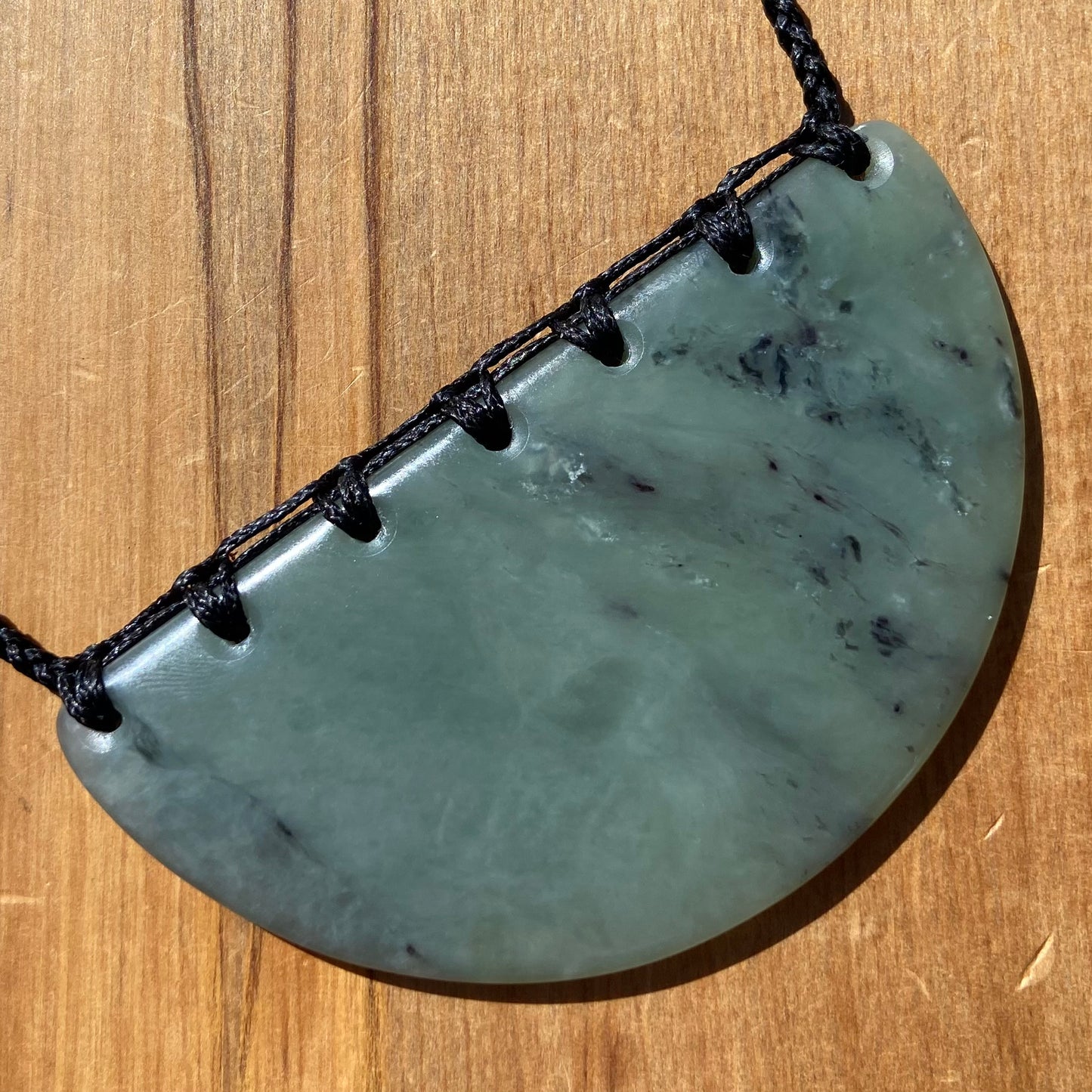 Breastplate pendant hand-carved from New Zealand inanga pounamu (greenstone). Front.
