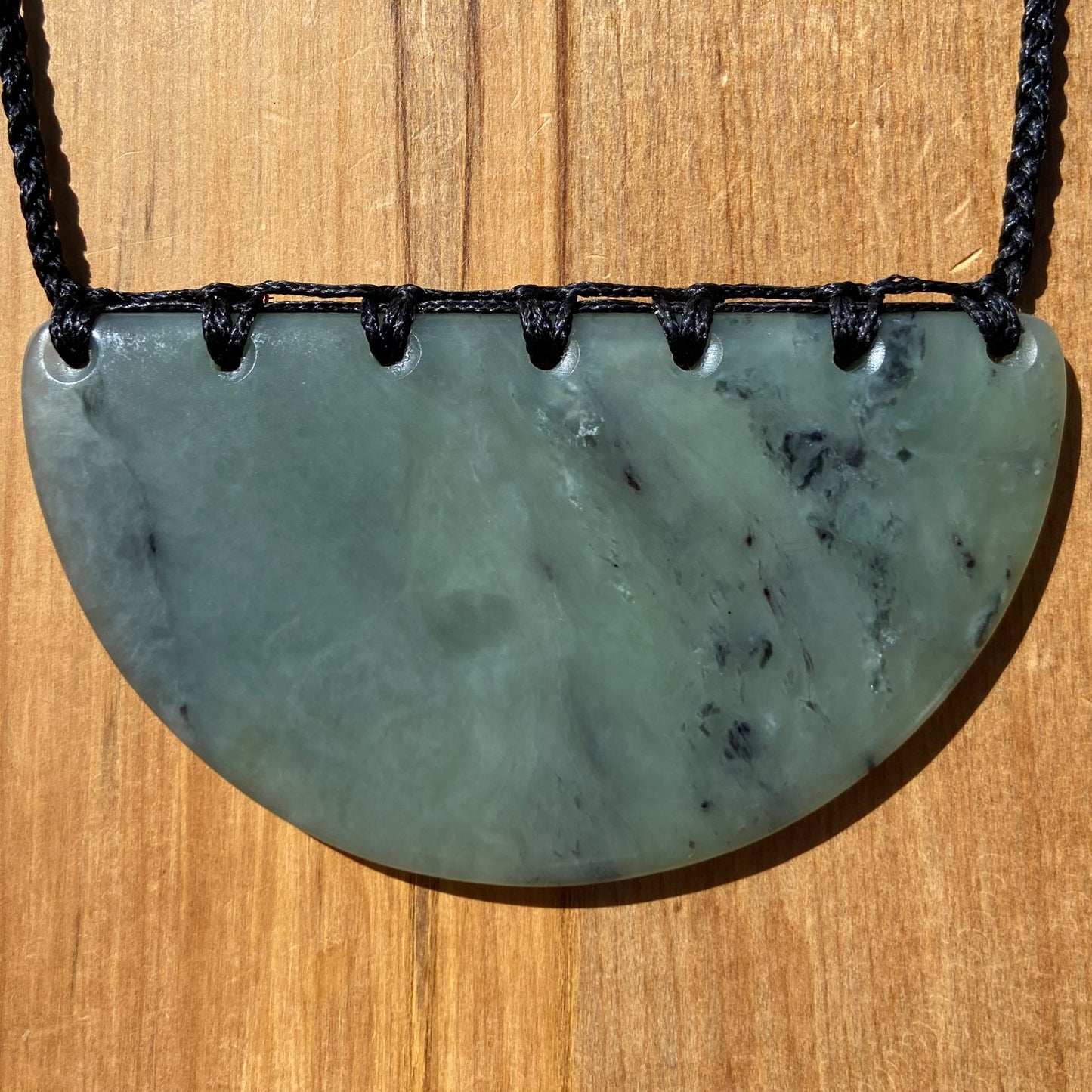Breastplate pendant hand-carved from New Zealand inanga pounamu (greenstone). Front.