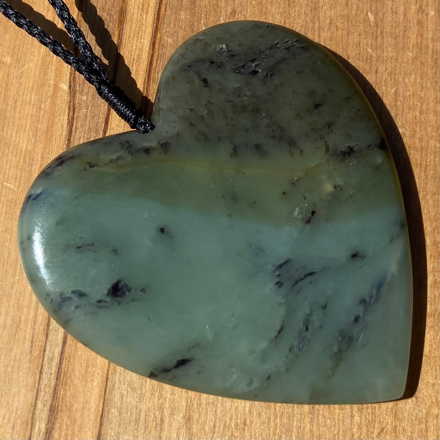 Pounamu heart shaped pendant carved from New Zealand South Westland inanga pounamu (greenstone). Front. Extra Large