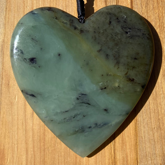 Pounamu heart shaped pendant carved from New Zealand South Westland inanga pounamu (greenstone). Front. Extra Large