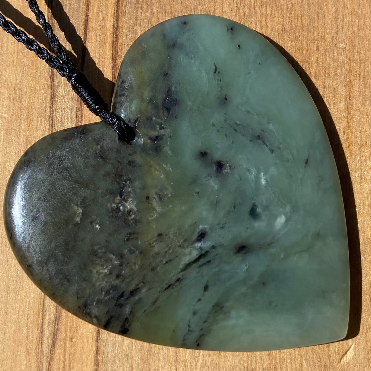 Pounamu heart shaped pendant carved from New Zealand South Westland inanga pounamu (greenstone). Back. Extra Large
