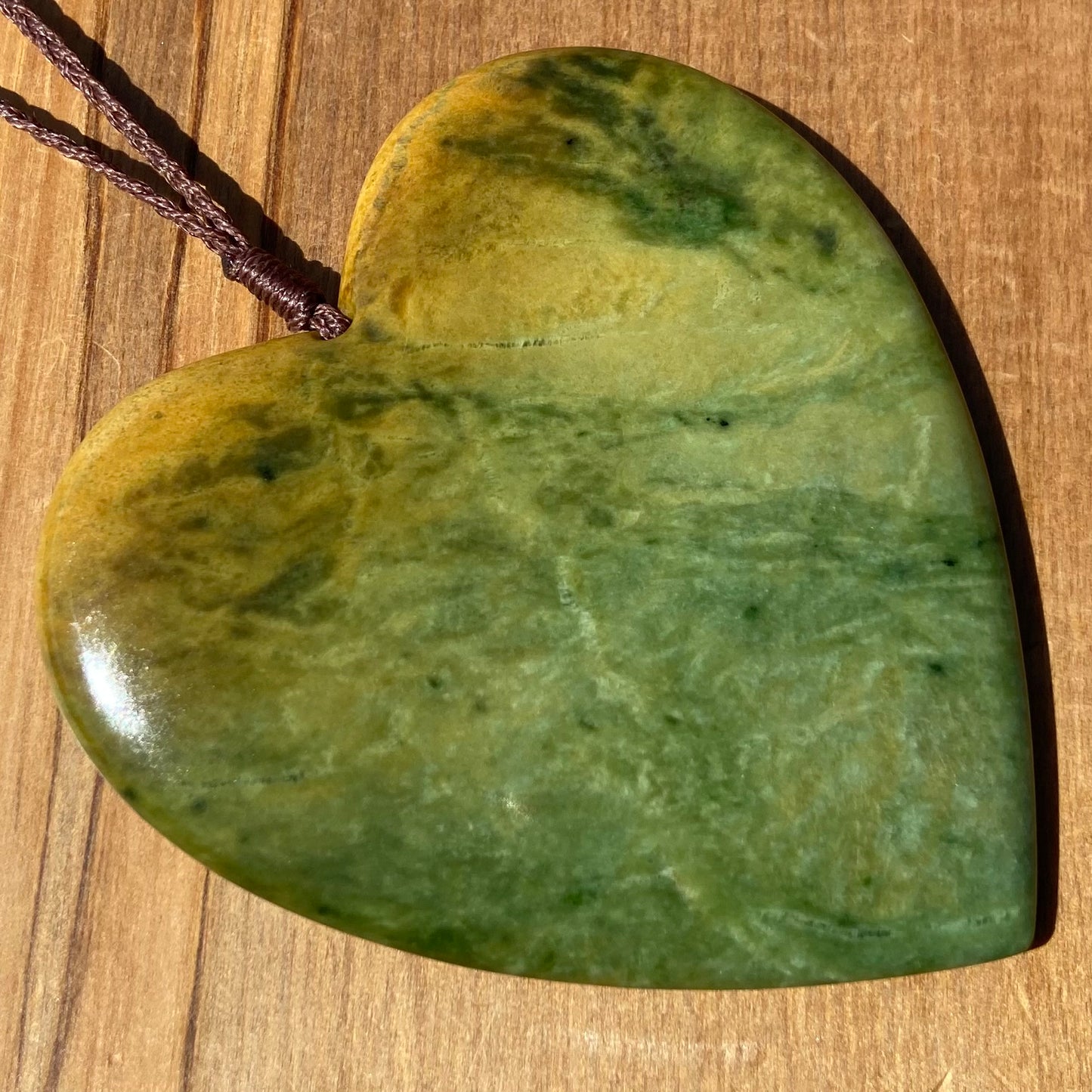 Pounamu heart shaped pendant carved from New Zealand Marsden Flower Jade (greenstone). Front. Extra Large
