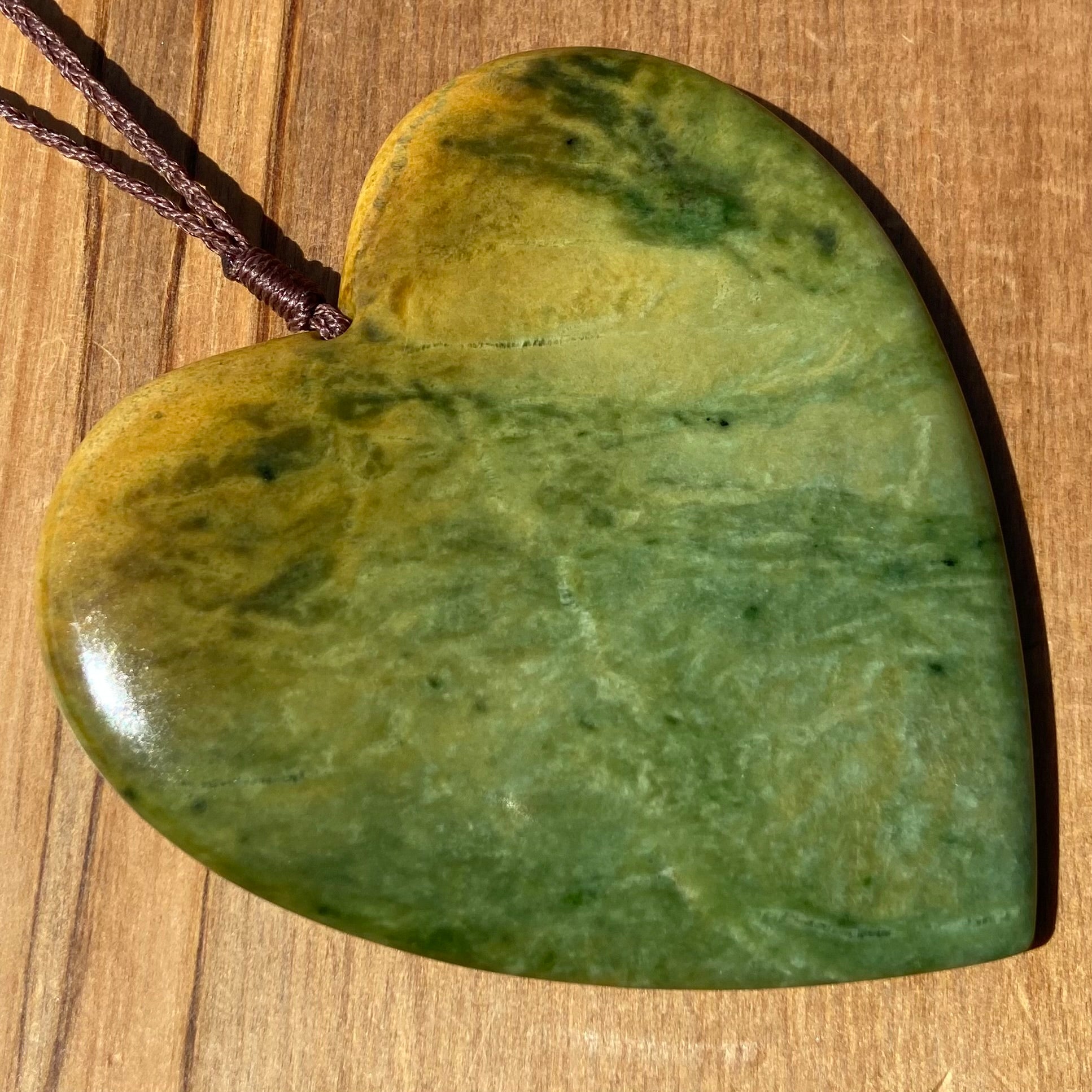 Pounamu heart shaped pendant carved from New Zealand Marsden Flower Jade (greenstone). Front. Extra Large