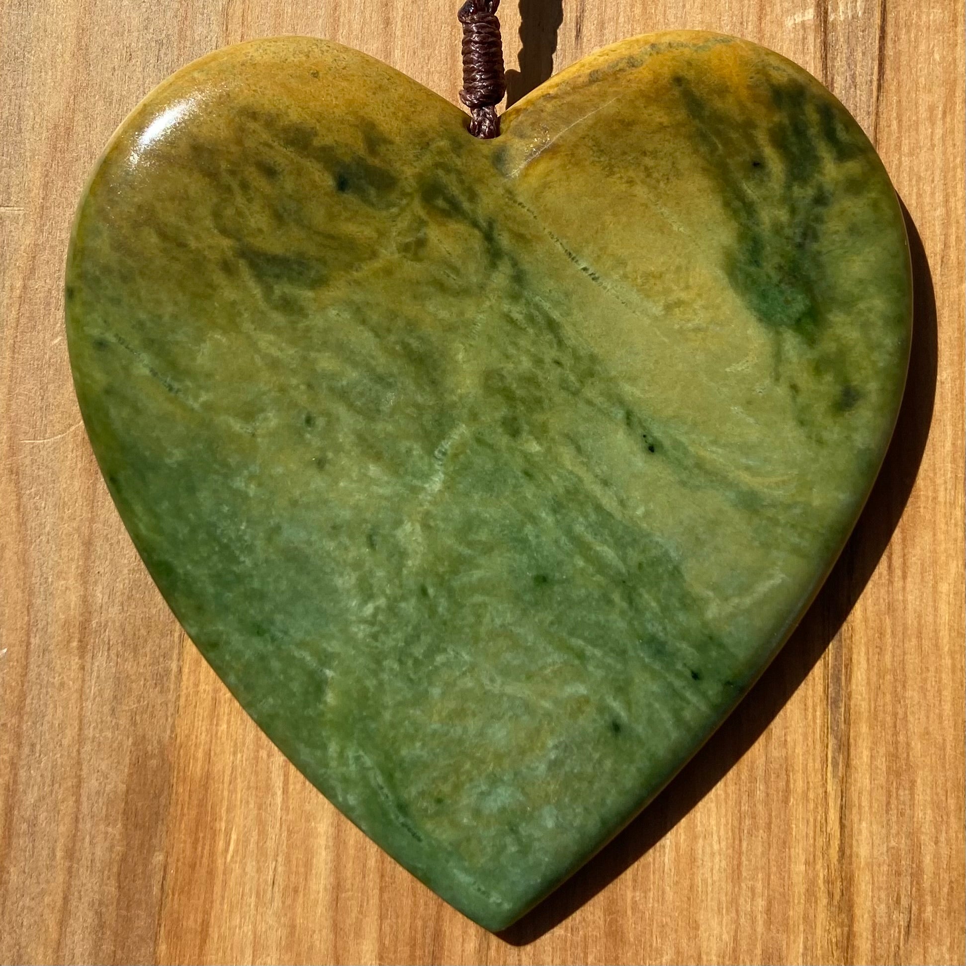 Pounamu heart shaped pendant carved from New Zealand Marsden Flower Jade (greenstone). Front. Extra Large
