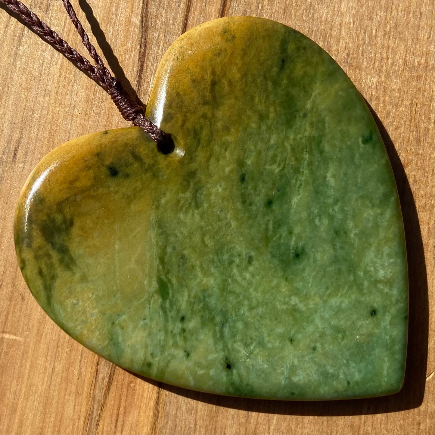 Pounamu heart shape pendant carved from New Zealand Marsden Flower Jade (greenstone). Back. Extra Large