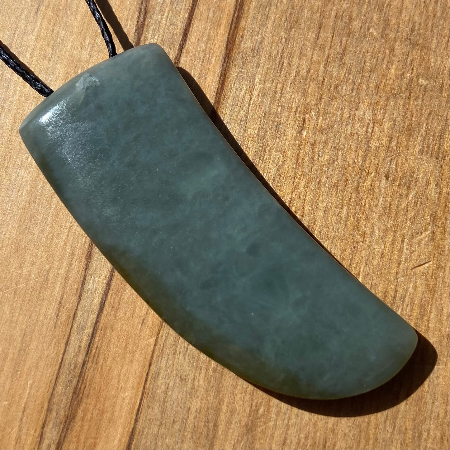Niho Tooth pendant hand-carved from New Zealand inanga pounamu (greenstone). Back.
