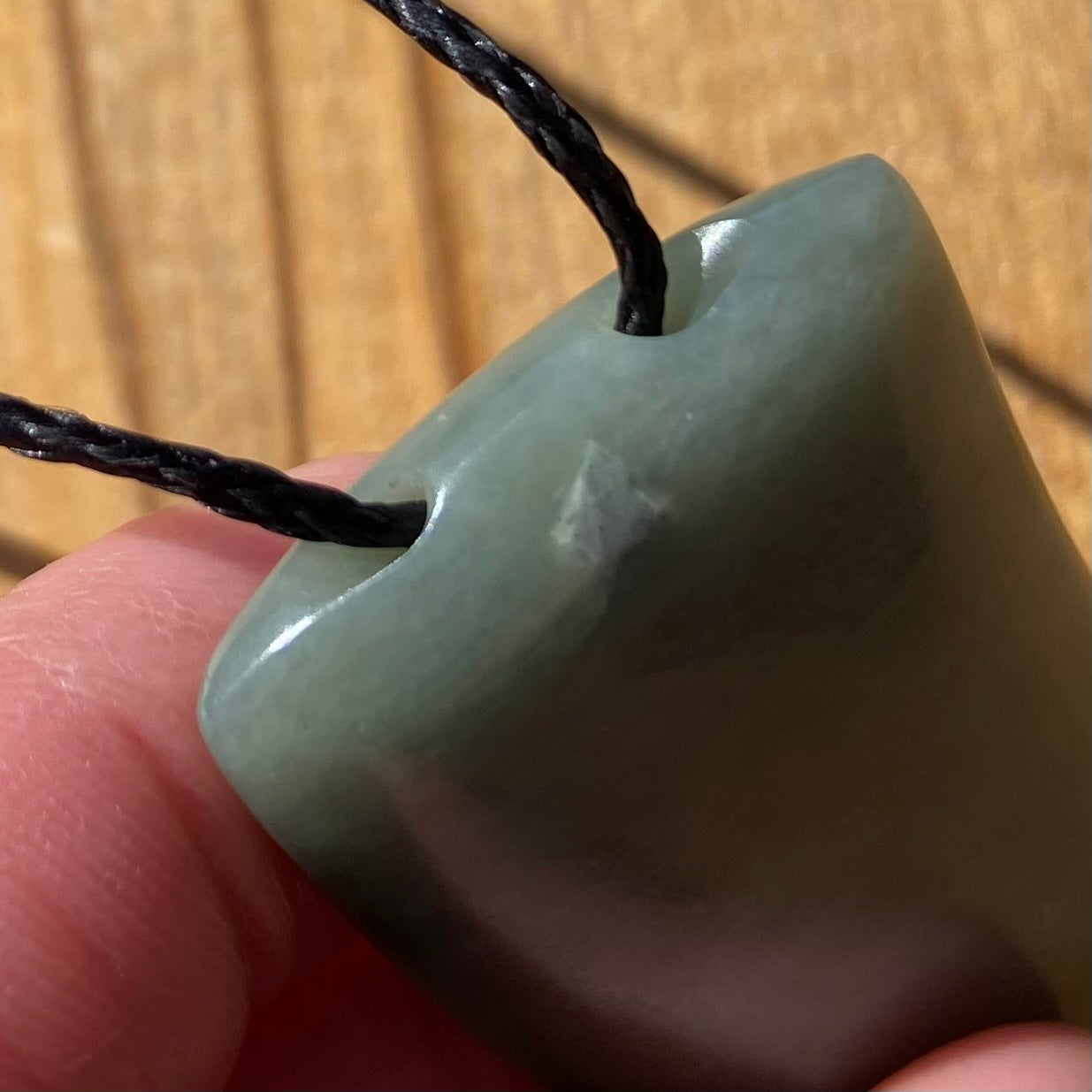 Niho Tooth pendant hand-carved from New Zealand inanga pounamu (greenstone). Cording.