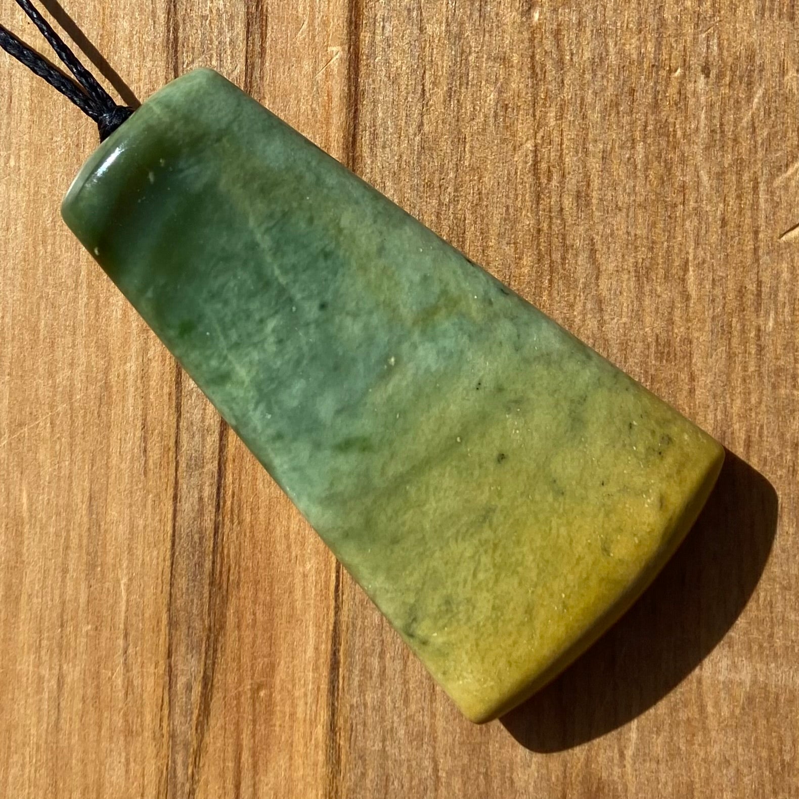 Pounamu toki pendant hand-carved from New Zealand Marsden Flower Jade pounamu (greenstone). Front.