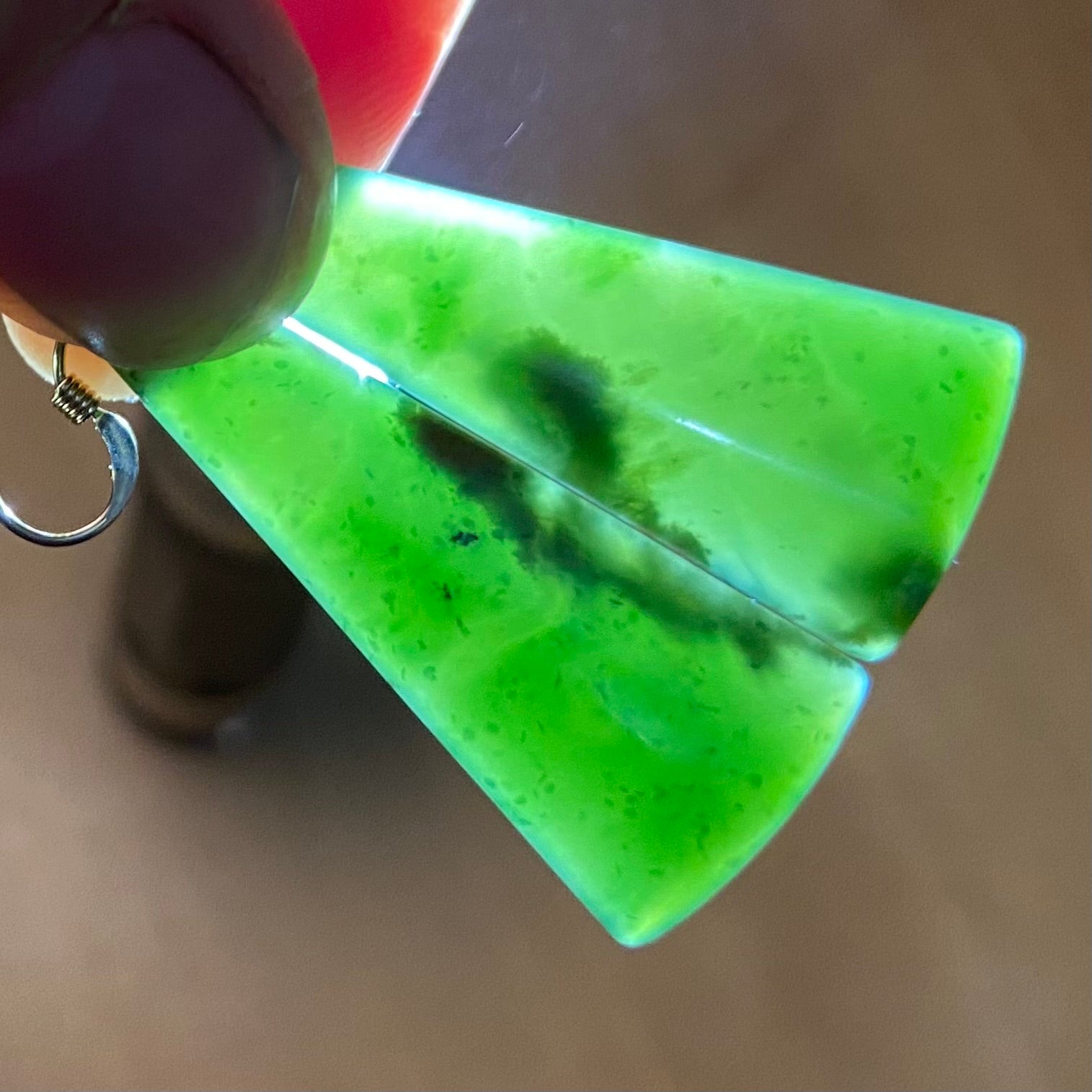 Pair of  toki earrings hand-carved from New Zealand Marsden Flower Jade/ pounamu (greenstone), with gold  fittings. Translucency.