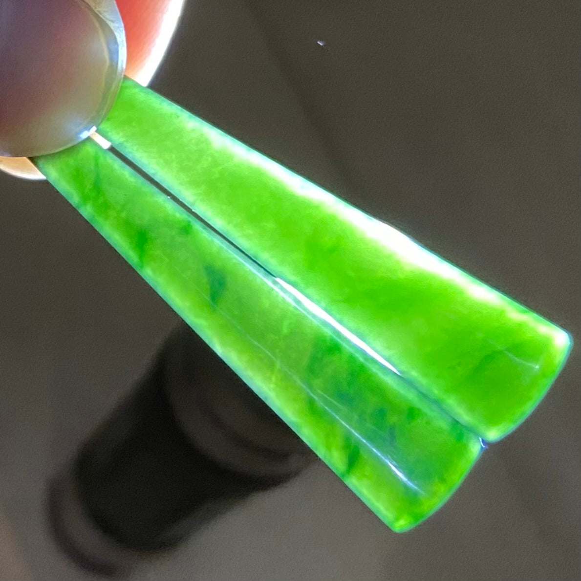 Pair of toki earrings hand-carved from New Zealand Kawakawa Jade/ pounamu (greenstone), with silver fittings. Translucency.