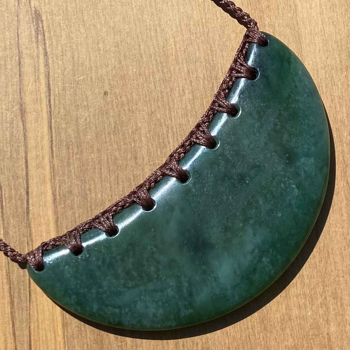 Breastplate pendant hand-carved from New Zealand kahurangi pounamu (greenstone). Angle.