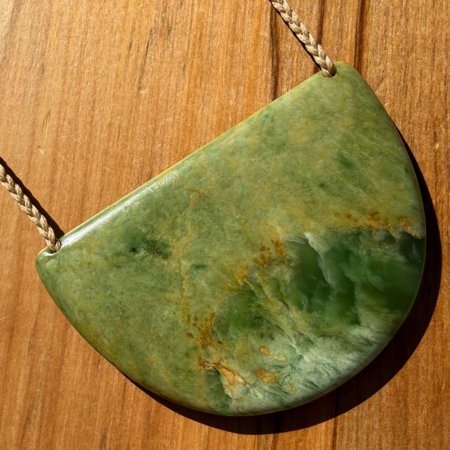 Breastplate pendant hand-carved from NZ Marsden Flower Jade pounamu (greenstone). Front.