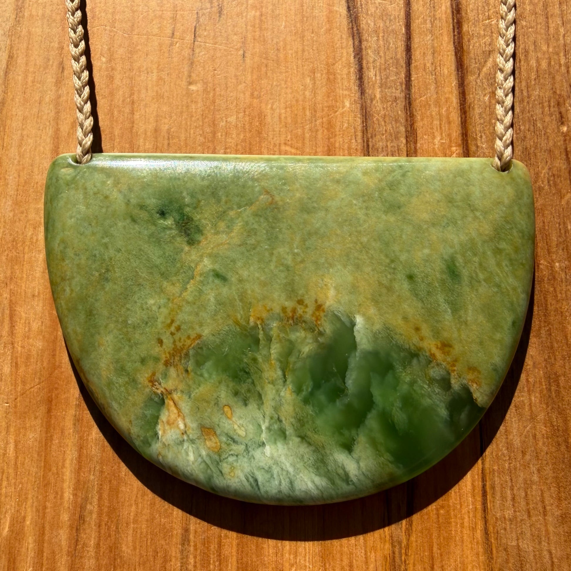 Breastplate pendant hand-carved from NZ Marsden Flower Jade pounamu (greenstone). Front.