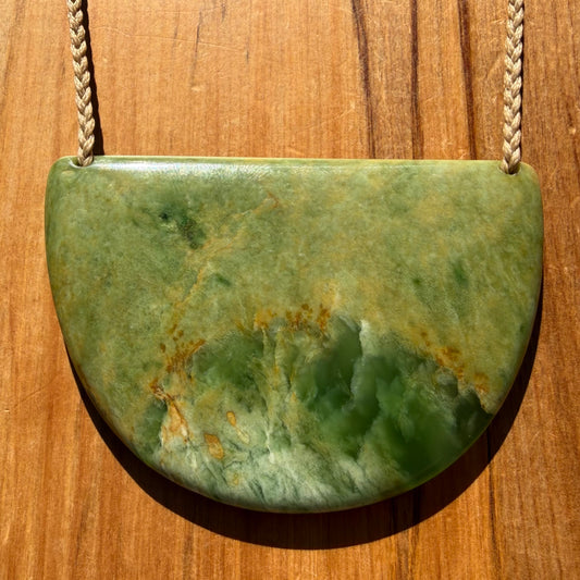 Breastplate pendant hand-carved from NZ Marsden Flower Jade pounamu (greenstone). Front.