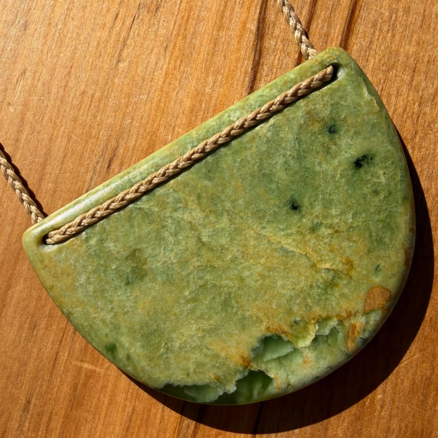 Breastplate pendant hand-carved from NZ Marsden Flower Jade pounamu (greenstone). Back.