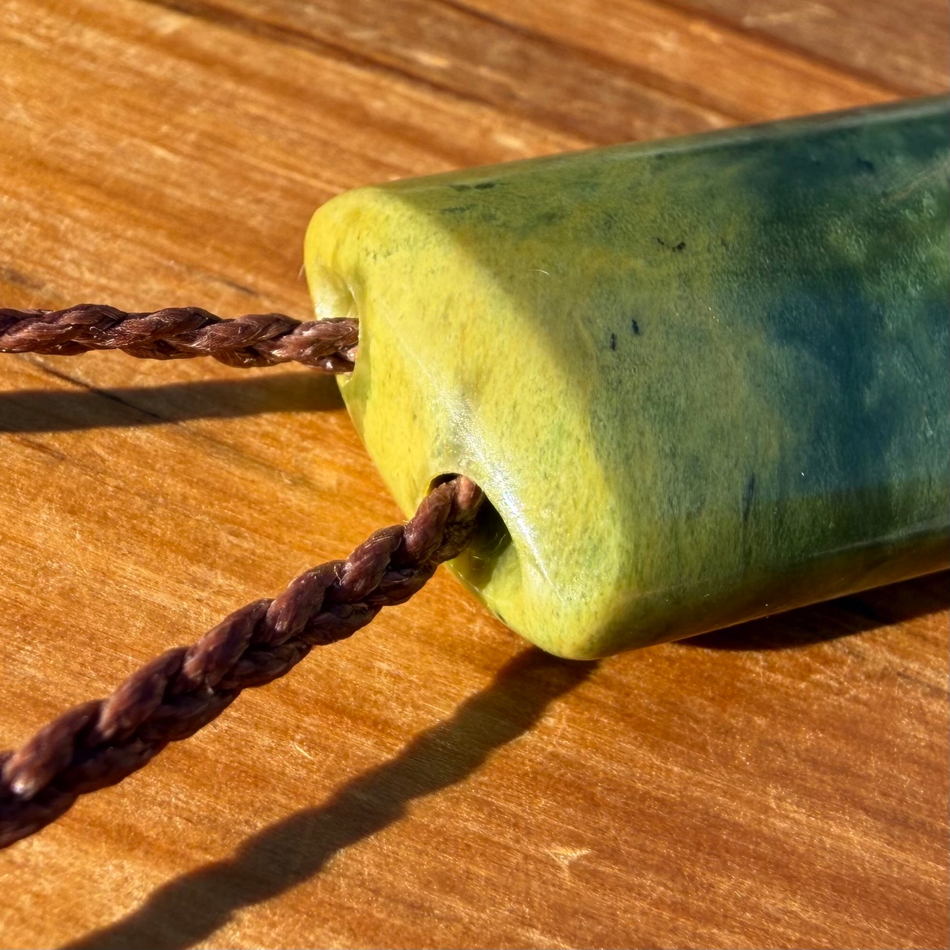 Pounamu toki pendant hand-carved from New Zealand Marsden Flower Jade pounamu (greenstone). Top.